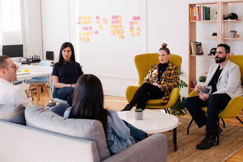 A group of people having a meeting in a casual setting